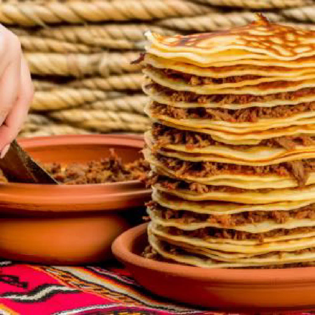Golden layered Albanian fli me mish filled with spiced meat