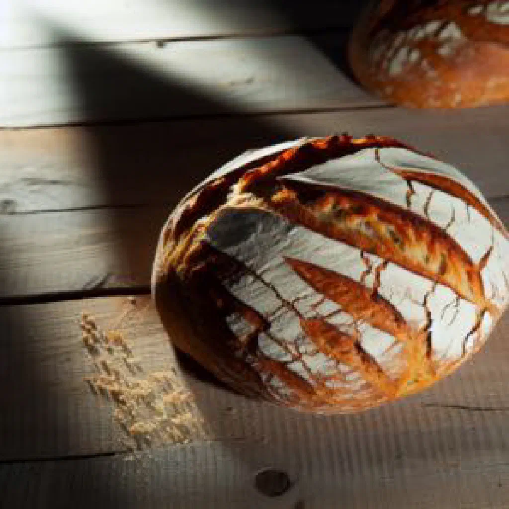Golden round loaf of traditional Albanian kulaç bread with a crisp crust