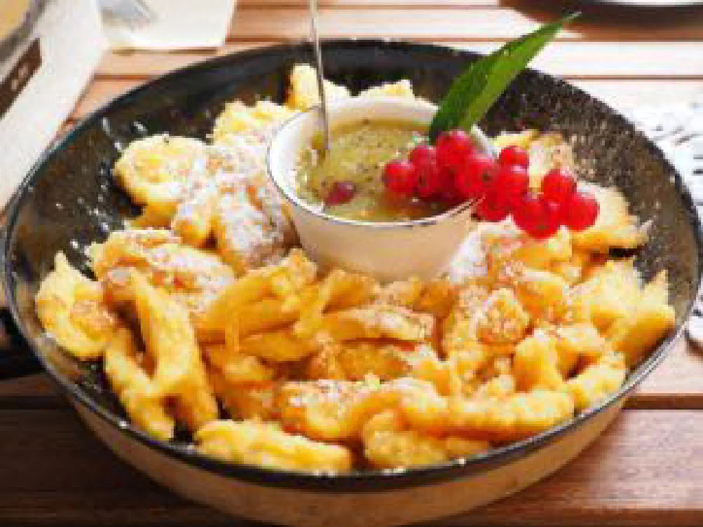 Fluffy torn Kaiserschmarrn pieces dusted with icing sugar