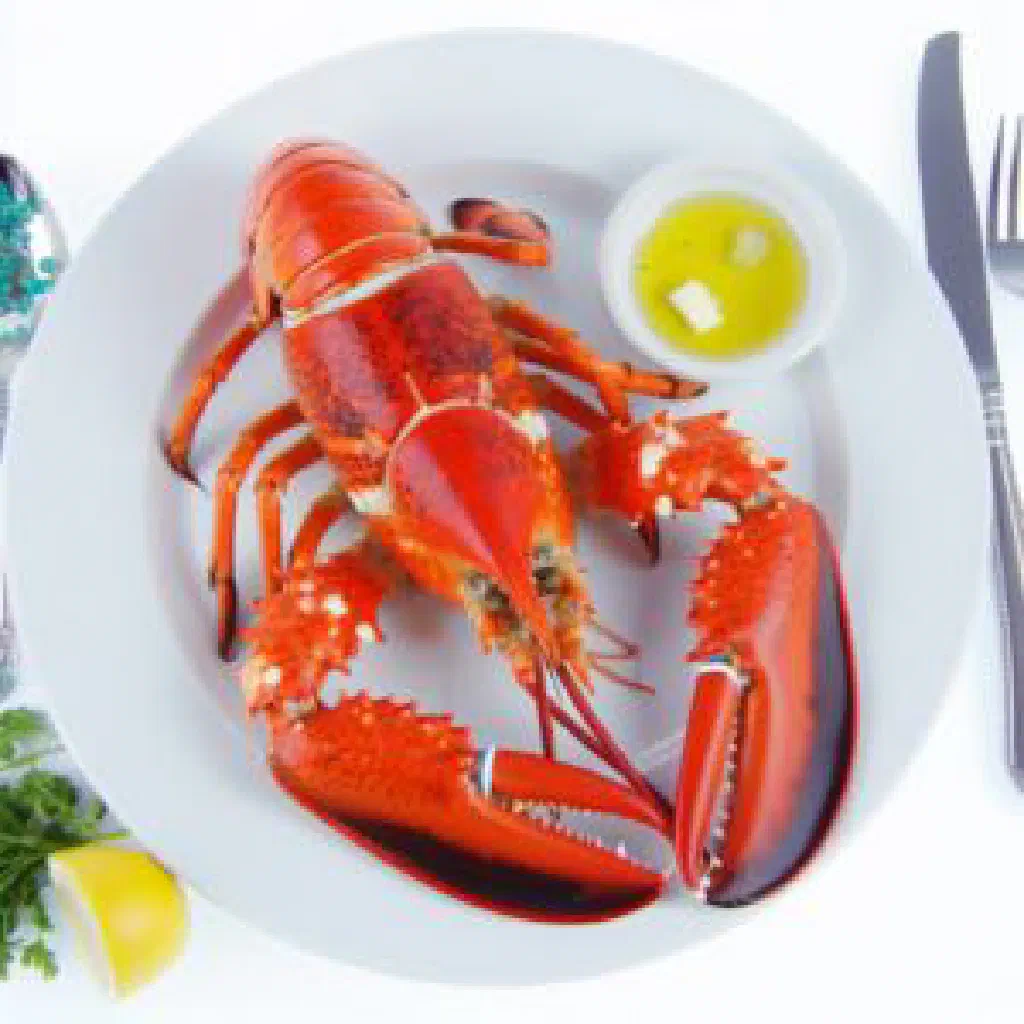 Grilled Bahamian rock lobster halves garnished with fresh herbs and lemon