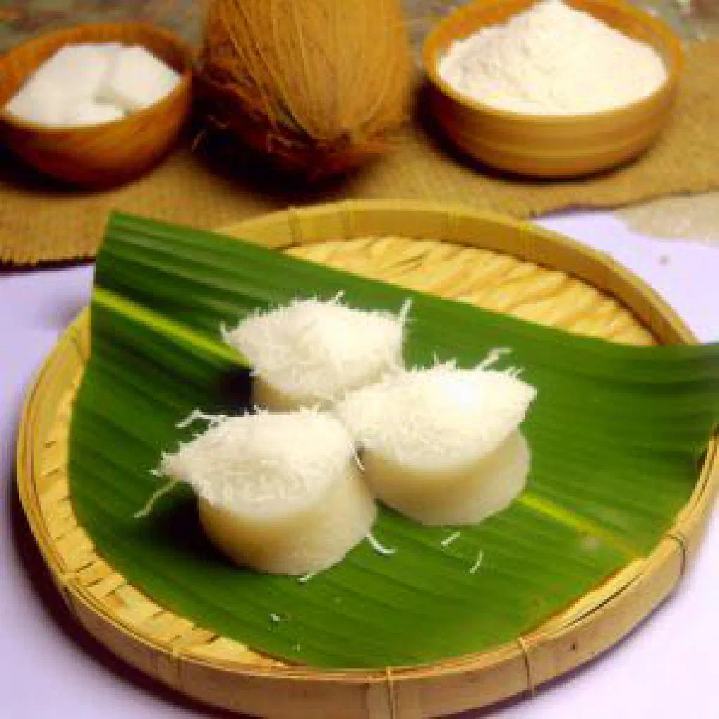 Soft steamed bhapa pitha rice cakes dusted with grated coconut