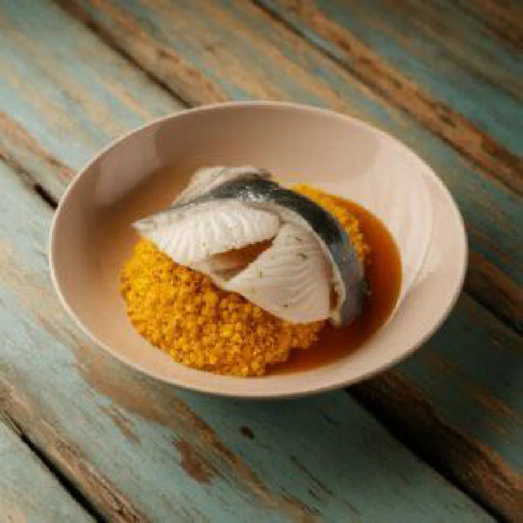 Steamed flying fish with coconut milk, vegetables and fresh herbs