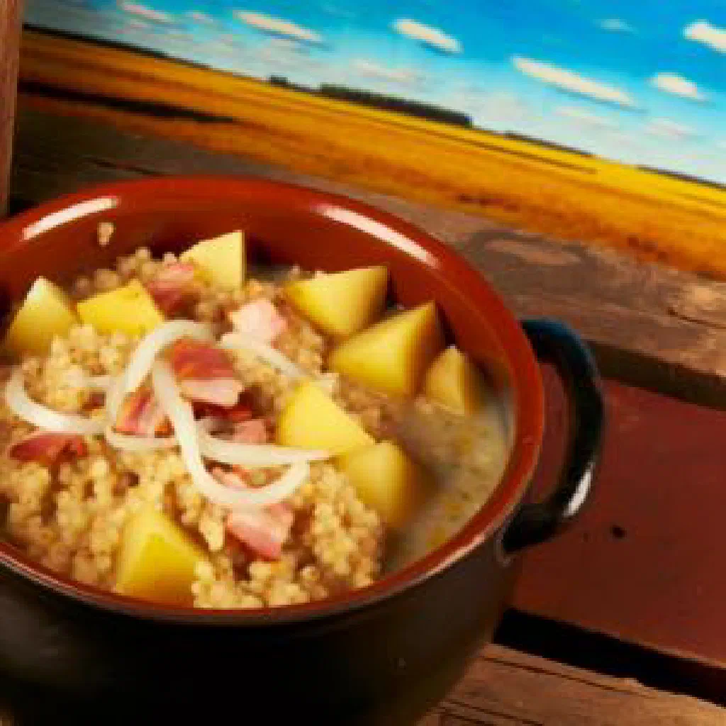 Bowl of Belarusian kulesh with buckwheat, potatoes and crisp bacon