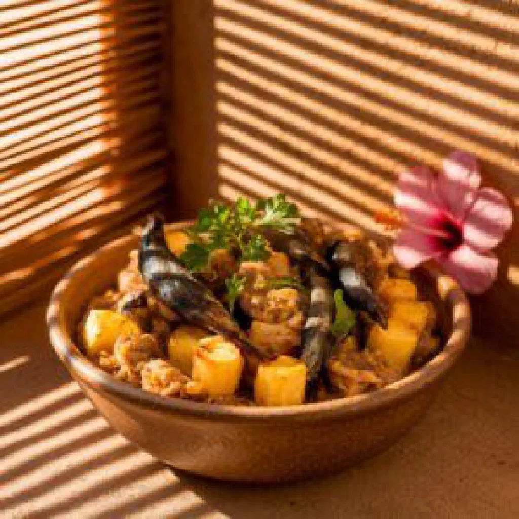 Mashed cassava served with a golden onion and paprika sauce