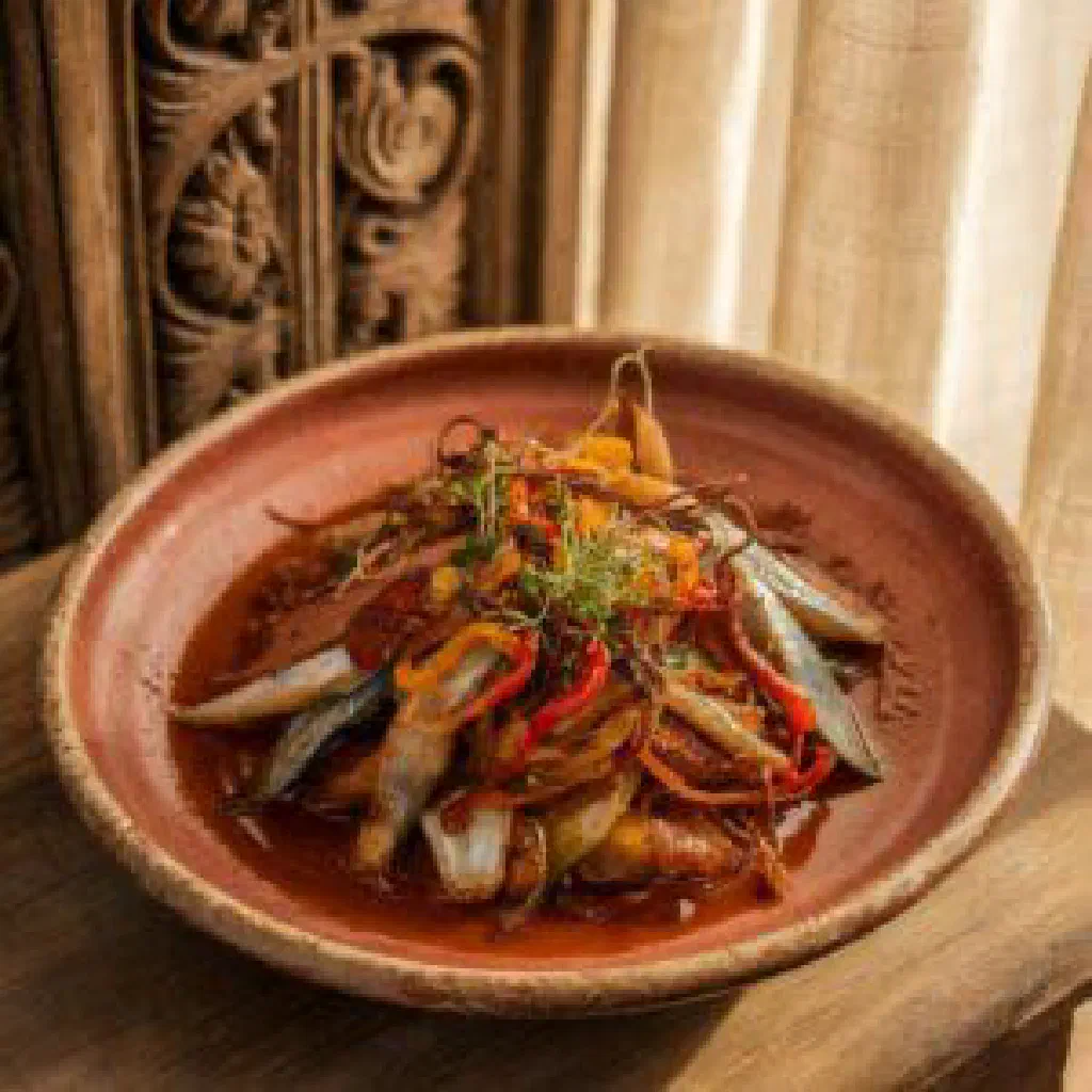 Bowl of Gnamankoudji, a creamy Beninese peanut stew with vegetables