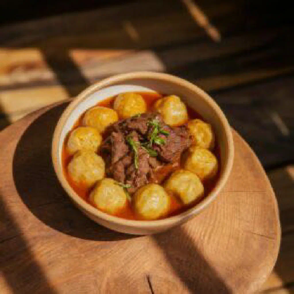 Bowl of creamy Botswanan mokoto with maize meal and beans