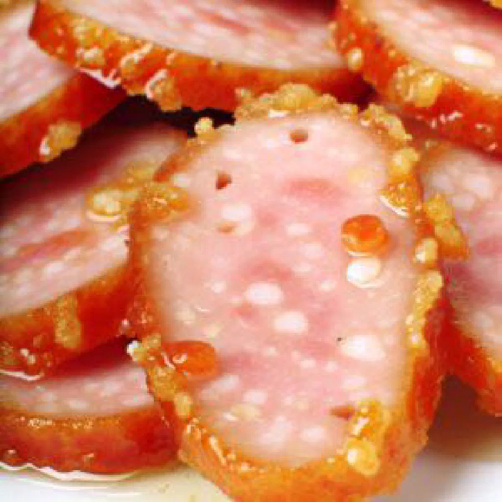 Sliced calabresa sausage pan-fried with golden onion rings and parsley