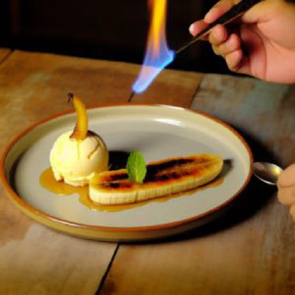 Caramelised flambéed banana halves served with vanilla ice cream