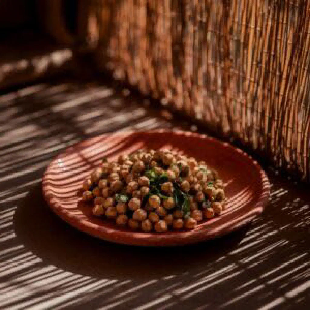 Bowl of Isogo rya Karanga with cassava and roasted peanuts