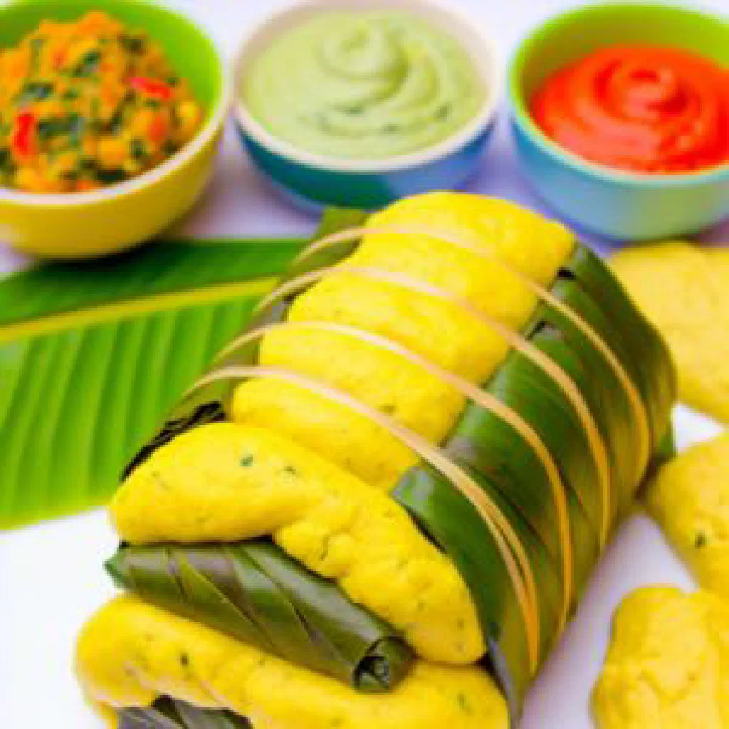 Steamed koki corn parcels unwrapped from banana leaves on a plate