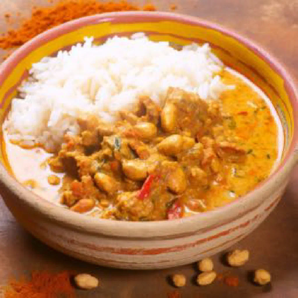 Kpem stew with tender meat in creamy peanut sauce, served with rice