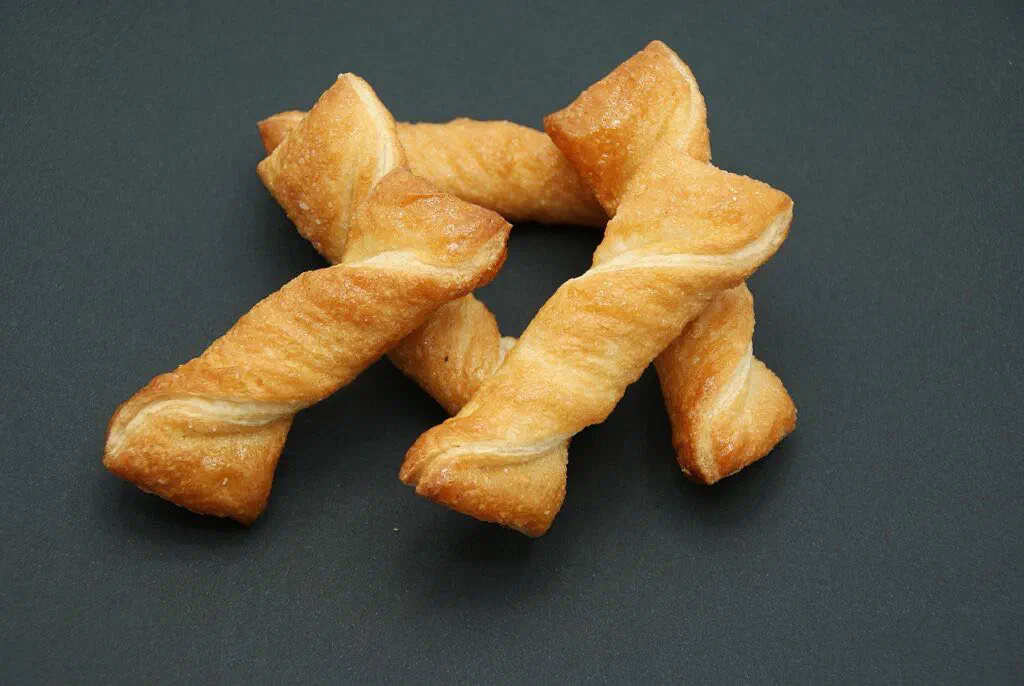 Golden deep-fried puff-puff dough balls piled in a bowl