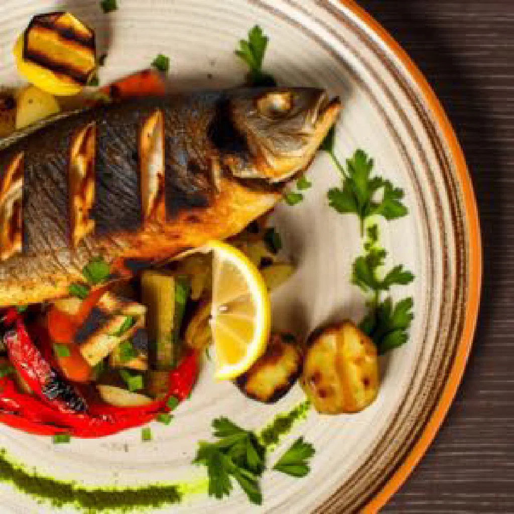 Grilled Arctic char fillet with crisp skin, lemon and fresh dill
