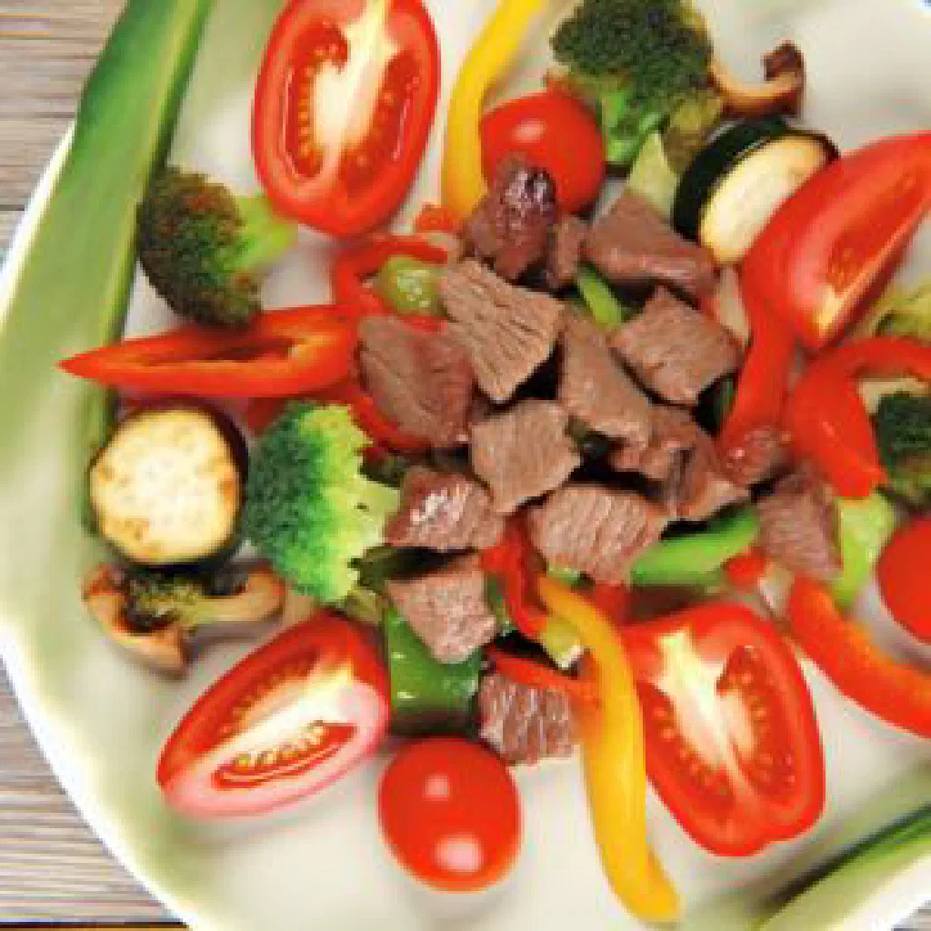 Cape Verdean bafa beef stew served with rice and fresh vegetables