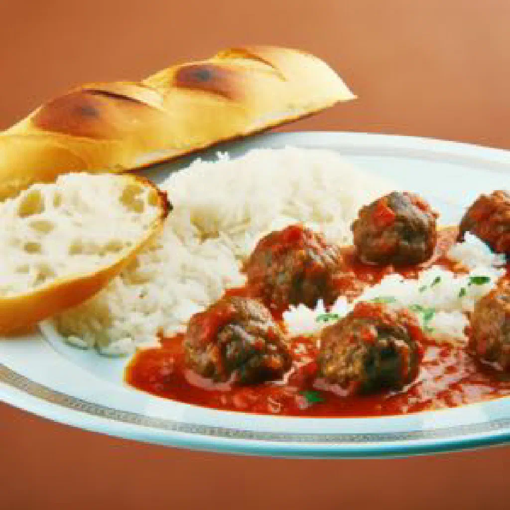 Kanda served on a plate with a spiced tomato and chilli sauce