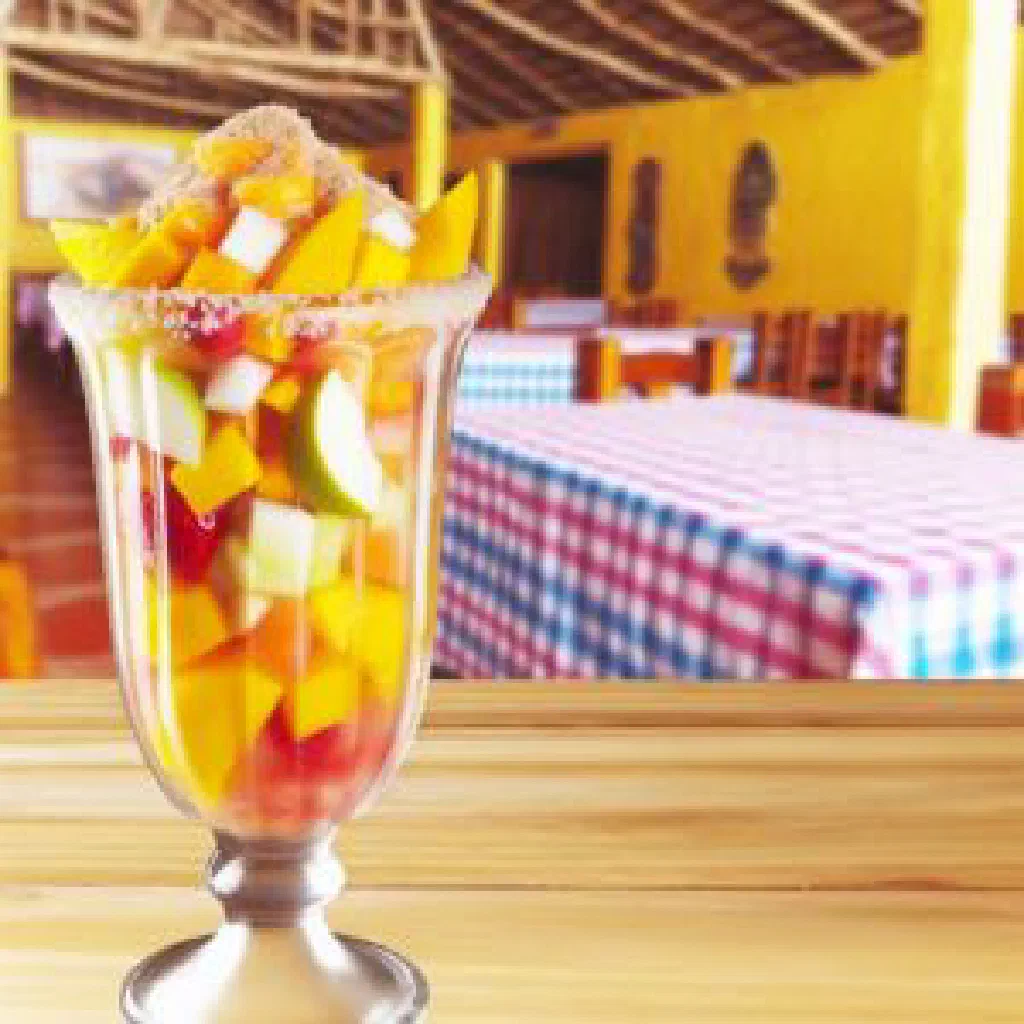 A colourful bowl of Colombian salpicón fruit salad with papaya, pineapple, mango and strawberries