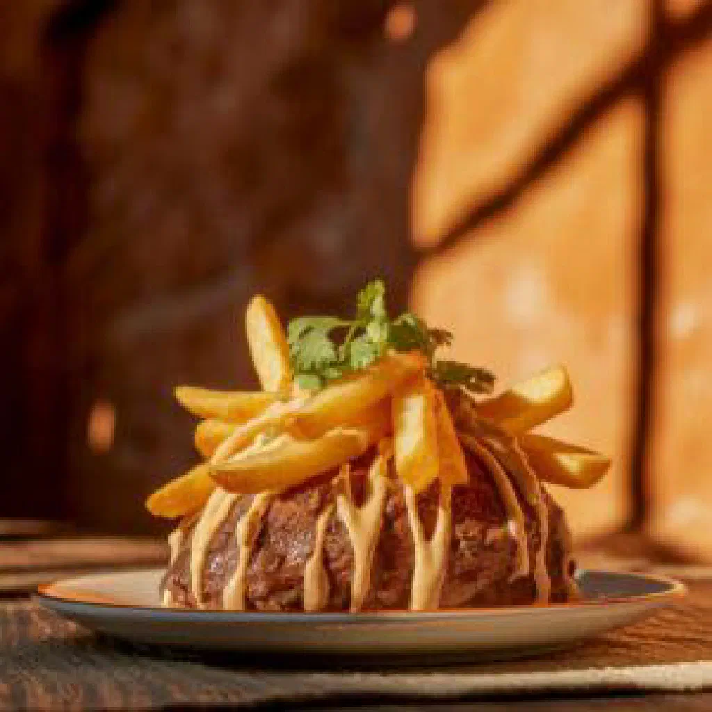Churrilanga with marinated beef, peppers and fresh herbs on a plate