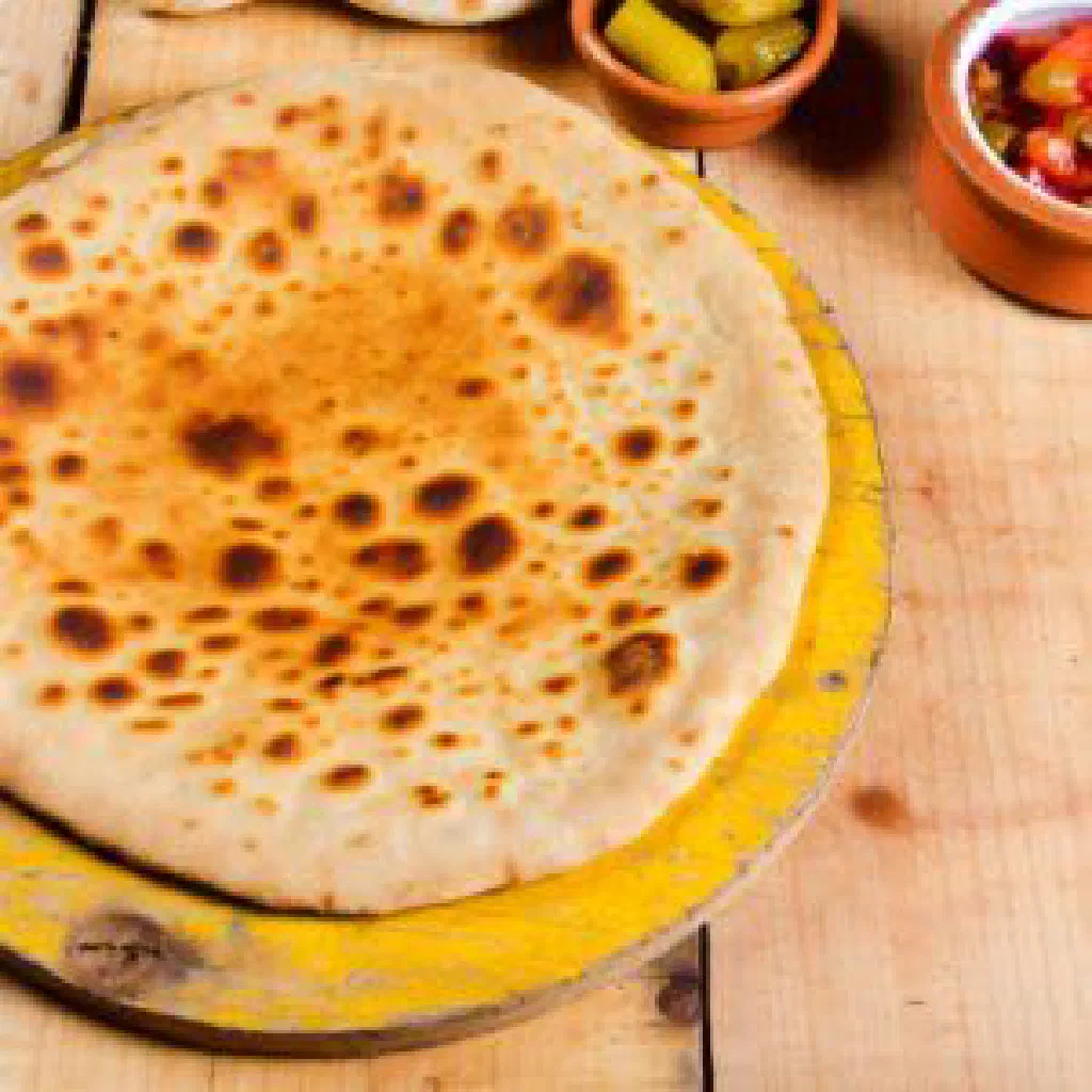 Round wholemeal Aish Merahrah flatbread on a plate