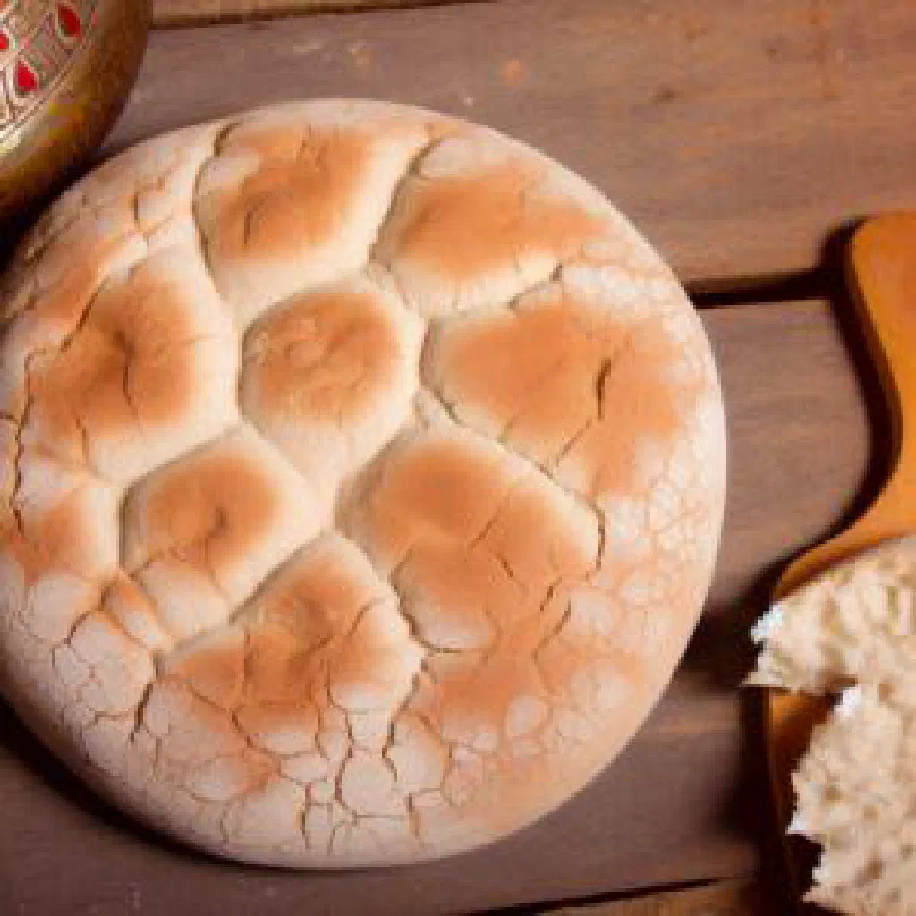 Crispy Eish Shamsi bread topped with a spiced bean and tomato mixture