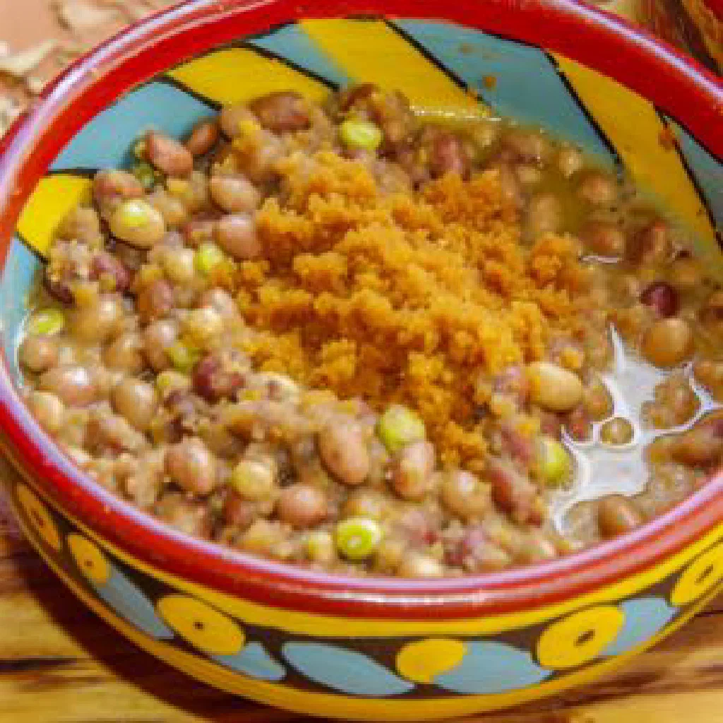 Bowl of Sidlawu Semabele maize porridge served with leafy greens