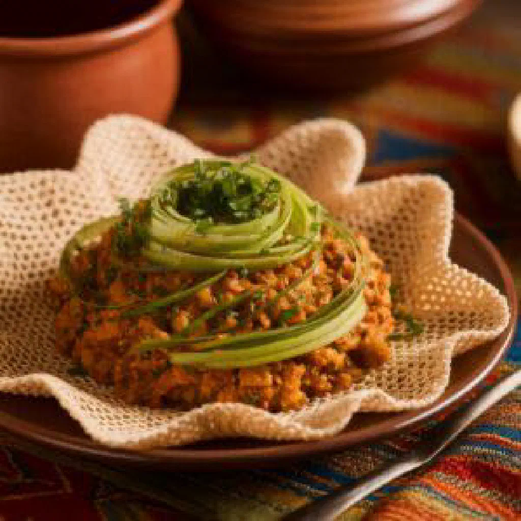Spiced Ethiopian gulban with tender meat and vegetables served on injera
