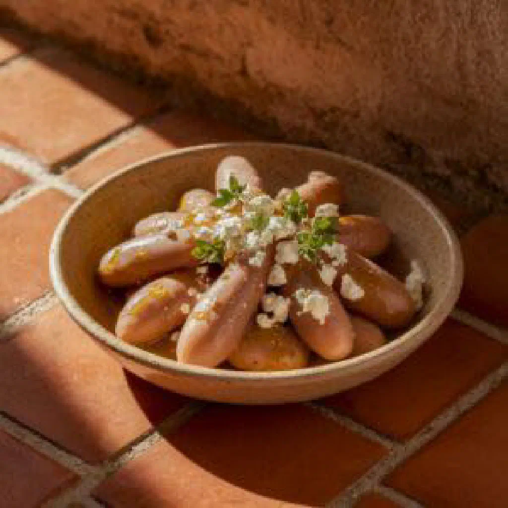 Giant baked beans in tomato sauce garnished with fresh herbs