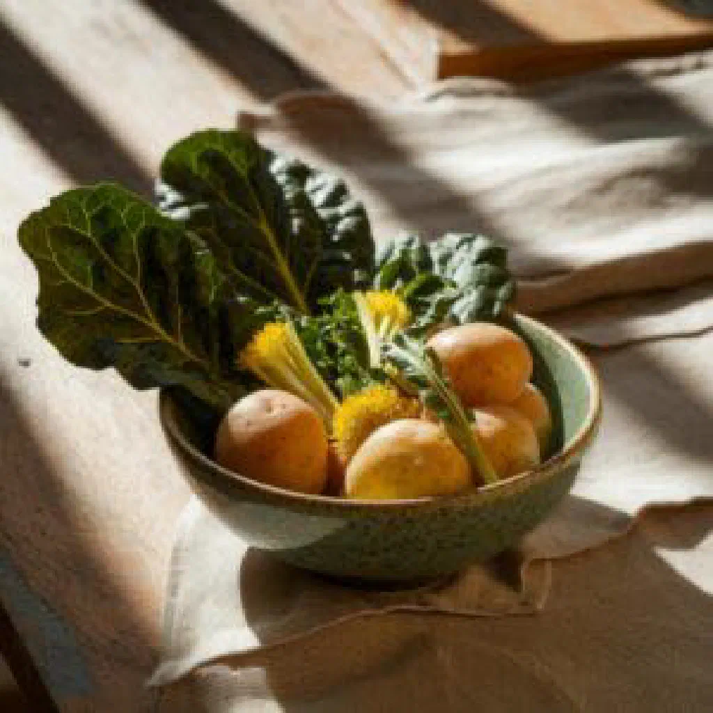 Boiled wild greens dressed with olive oil and lemon on a plate