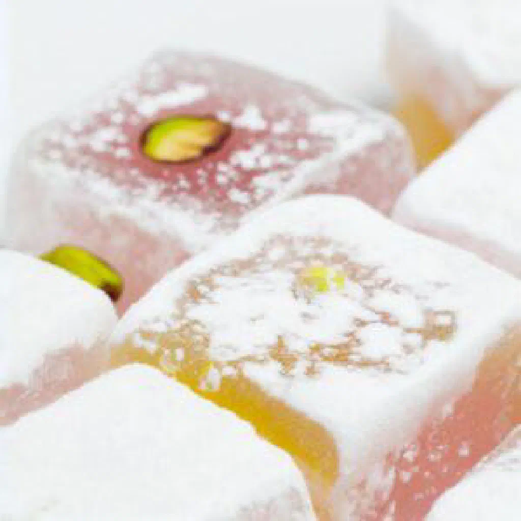 Powdered loukoum cubes dusted with icing sugar and topped with pistachios