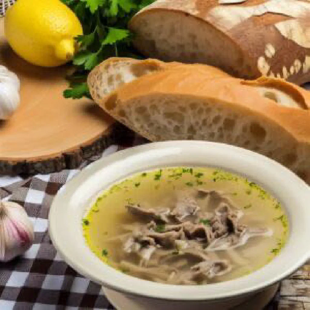 A steaming bowl of Greek patsas tripe soup garnished with fresh parsley