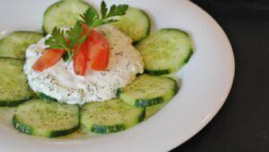A bowl of creamy Greek tzatziki drizzled with olive oil