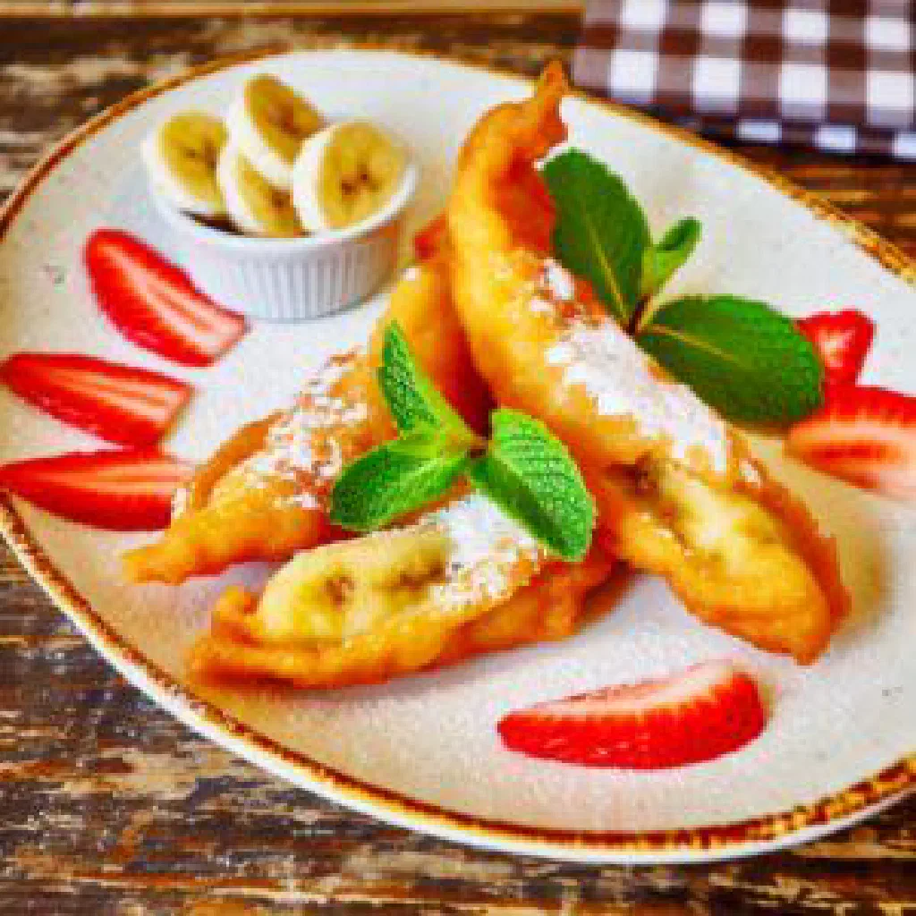 Golden fried plantain pieces served warm on a plate