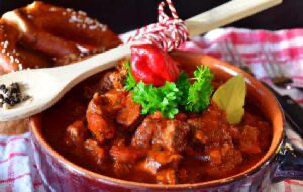Hungarian goulash in a pan, richly coloured with paprika