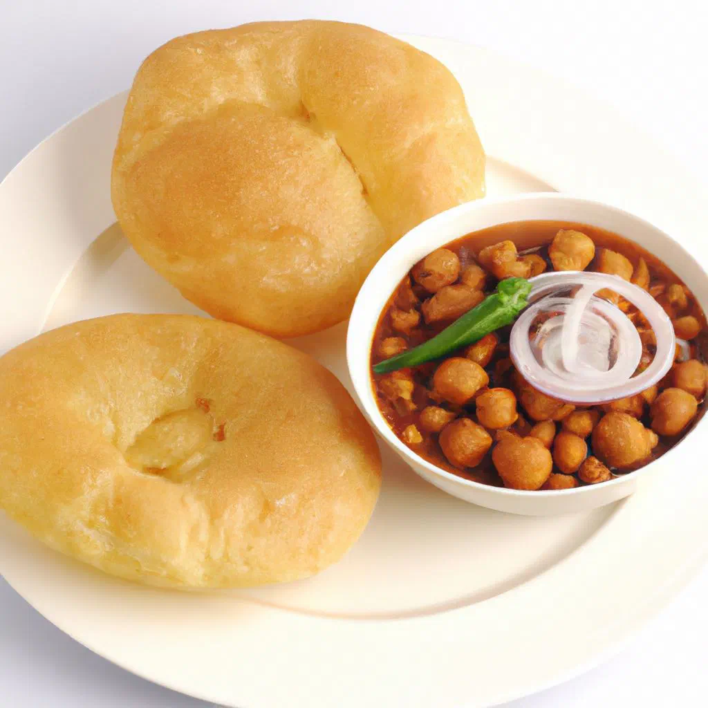 Chole bhature with spicy chickpea curry and puffed fried bread