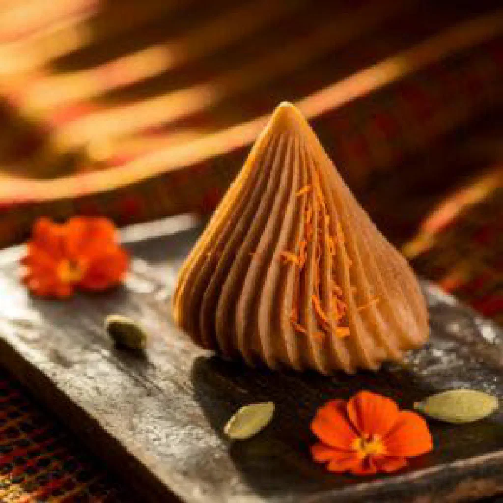 Steamed modak dumplings shaped like teardrops on a plate