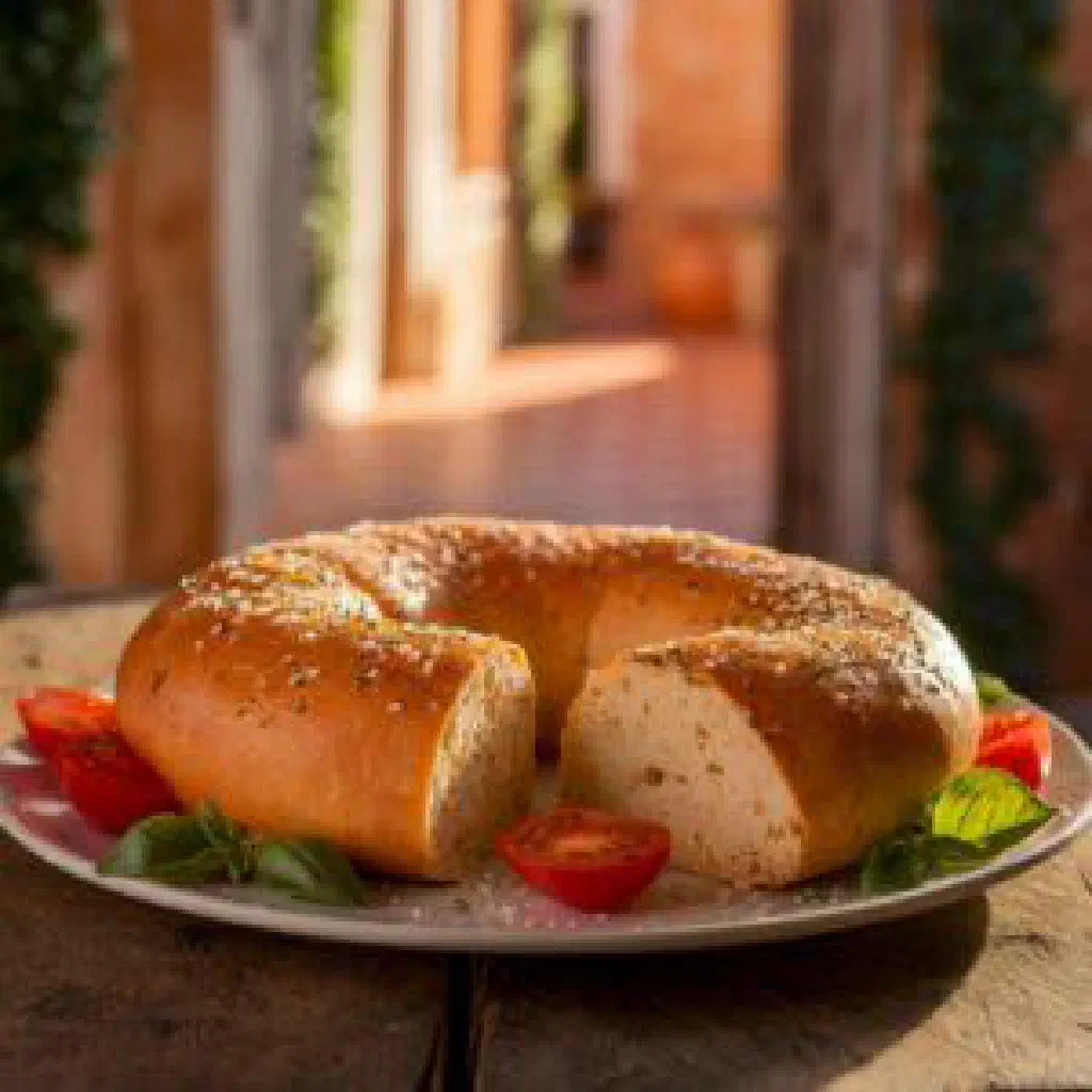 A rustic round Pinza Veneta studded with dried fruit and nuts, cut into slices