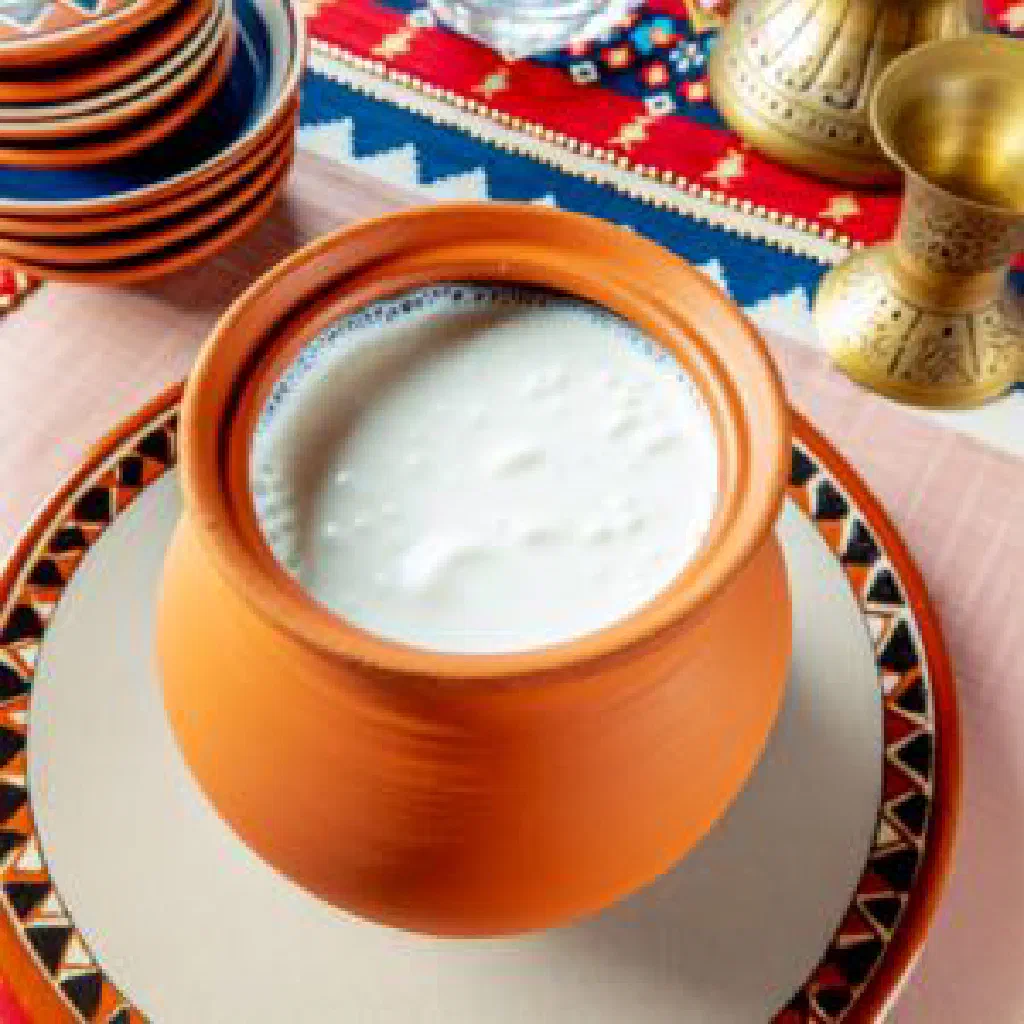 Glass of chilled laban yoghurt drink garnished with fresh mint