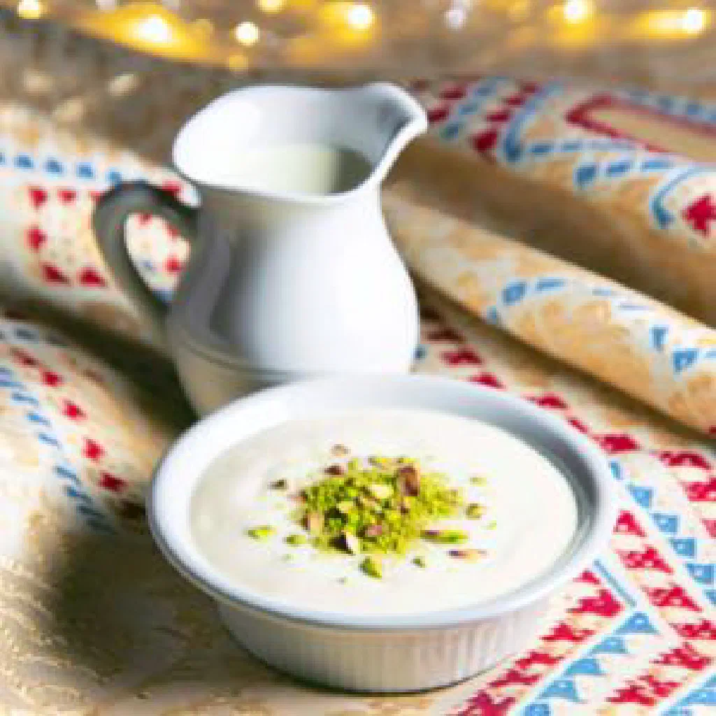 Creamy muhallabia milk pudding topped with chopped pistachios