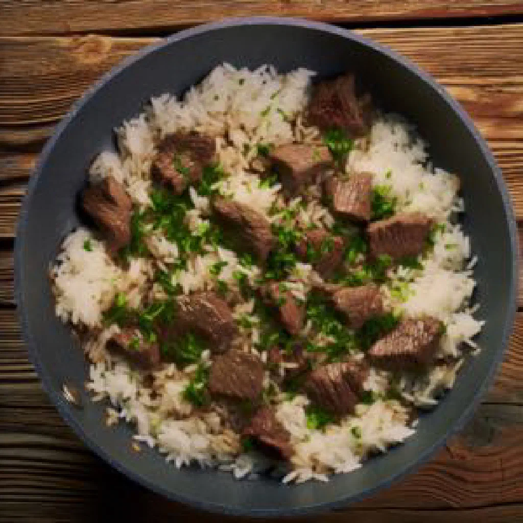 Talqan with rice, tender meat, carrots and raisins on a serving platter