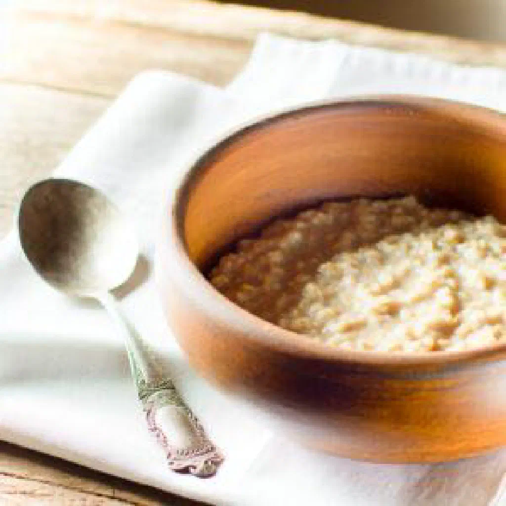 A bowl of Zhent made from ground grains, drizzled with honey and butter