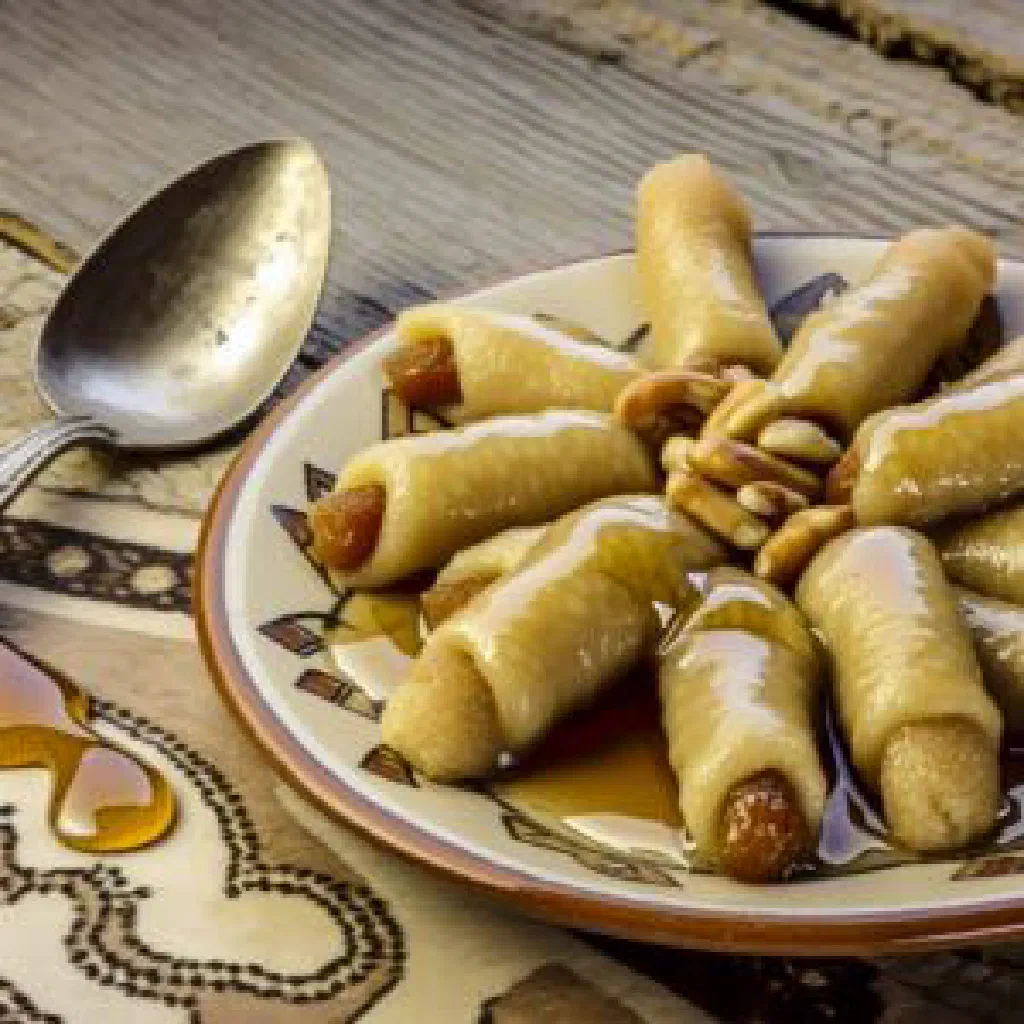 Filled Lebanese pastries drizzled with syrup and garnished with chopped nuts