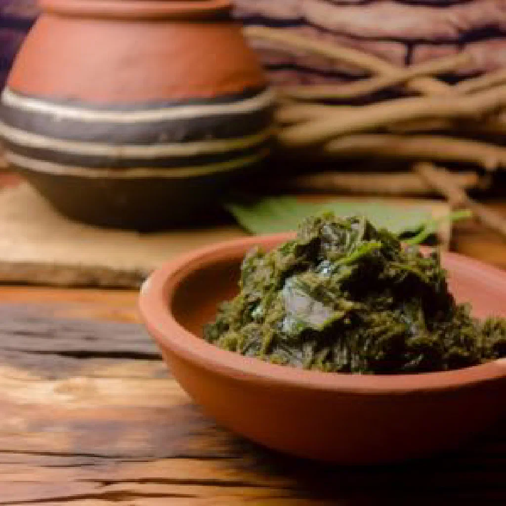 A bowl of moroho, sautéed leafy greens with onion and garlic