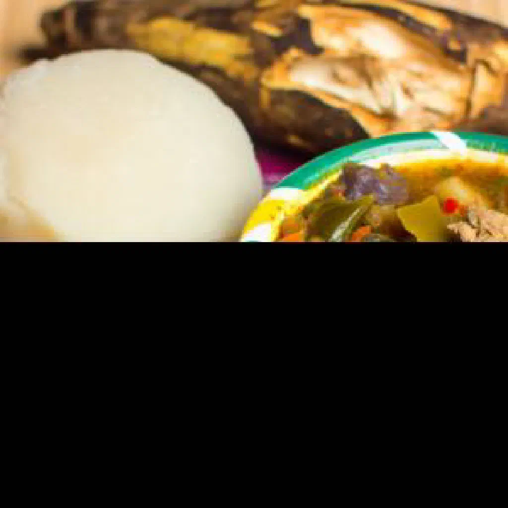 Soft dumboy dumplings served in a bowl of rich Liberian soup with leafy greens