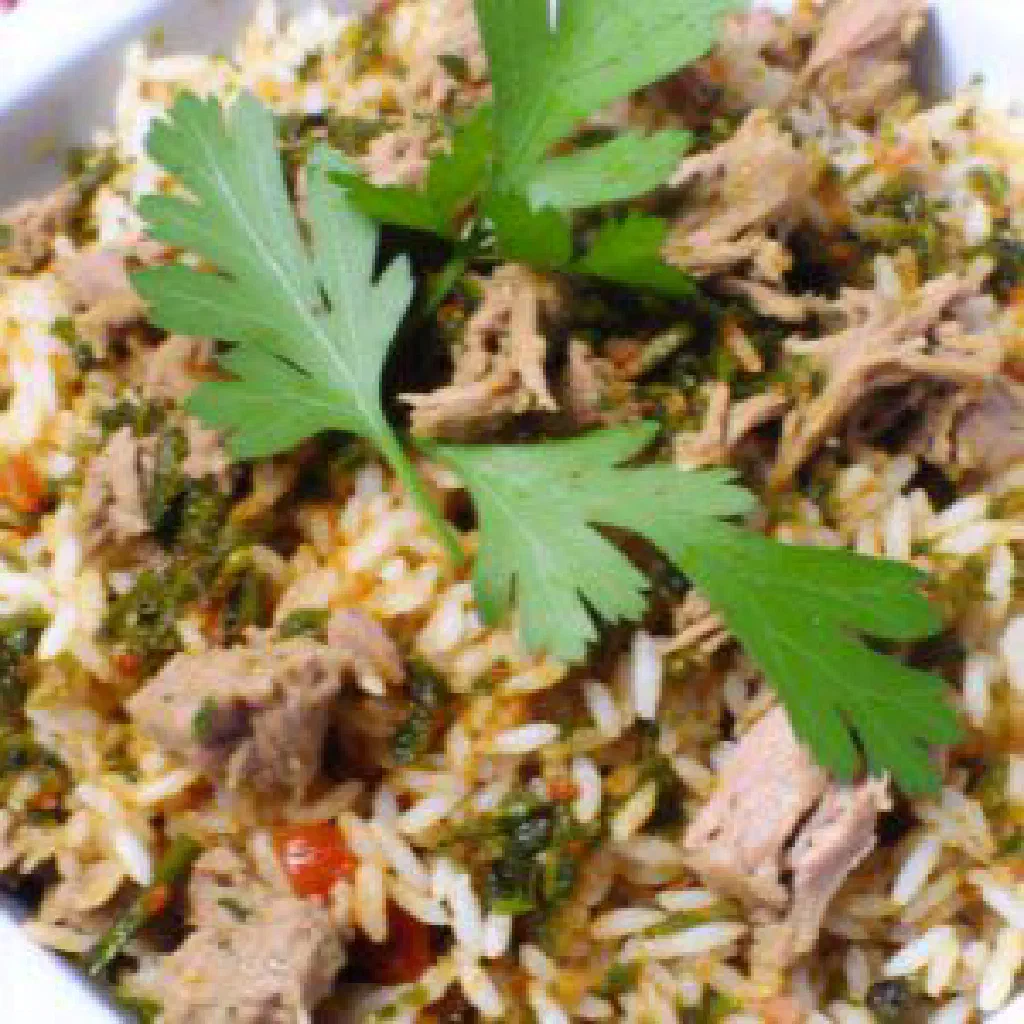 Fatta with tender meat, rice and tomato sauce over crisp flatbread