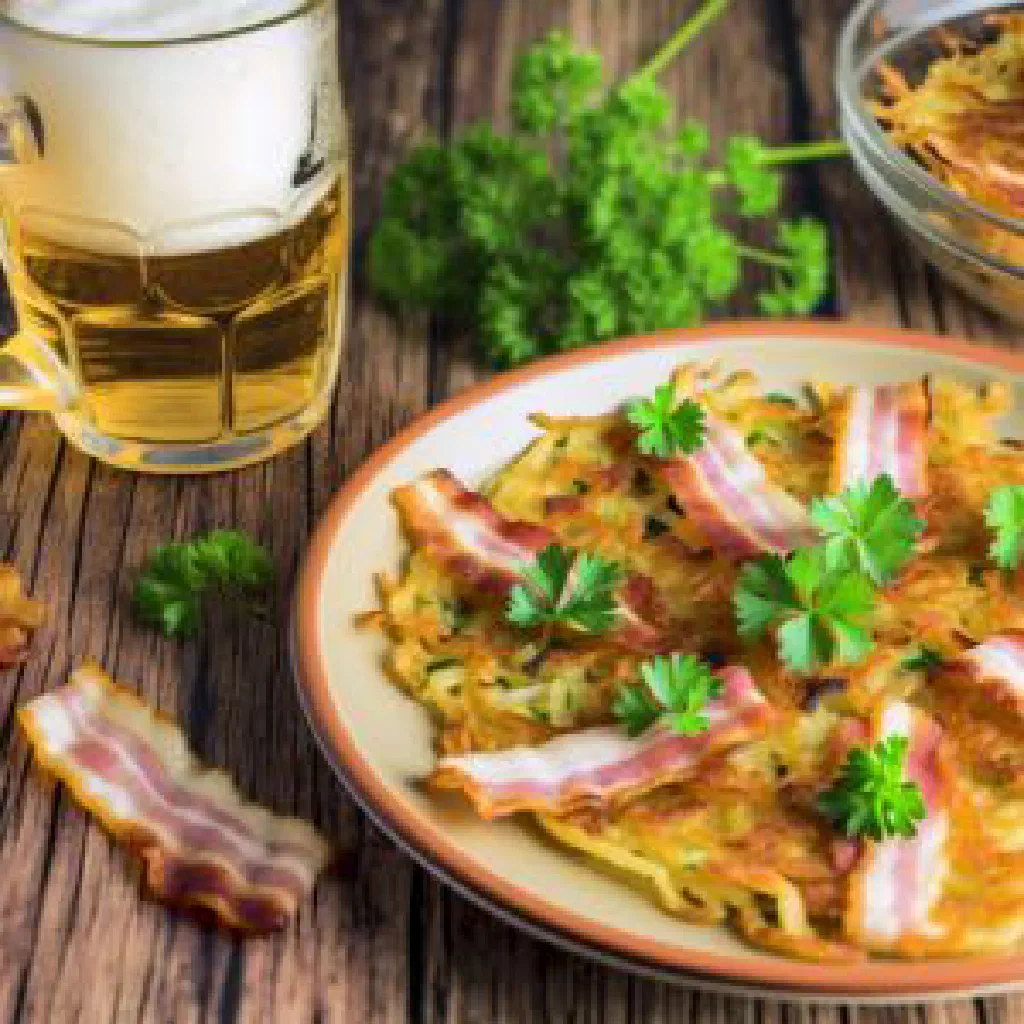 Golden-brown Luxembourgish bacon and potato fritters on a plate