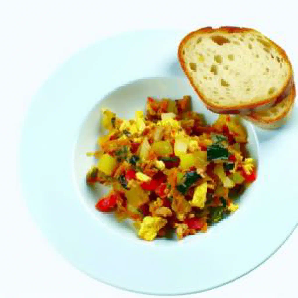 Pan of Verwurrelt Gedanken with potatoes, bacon and egg, scattered with fresh herbs