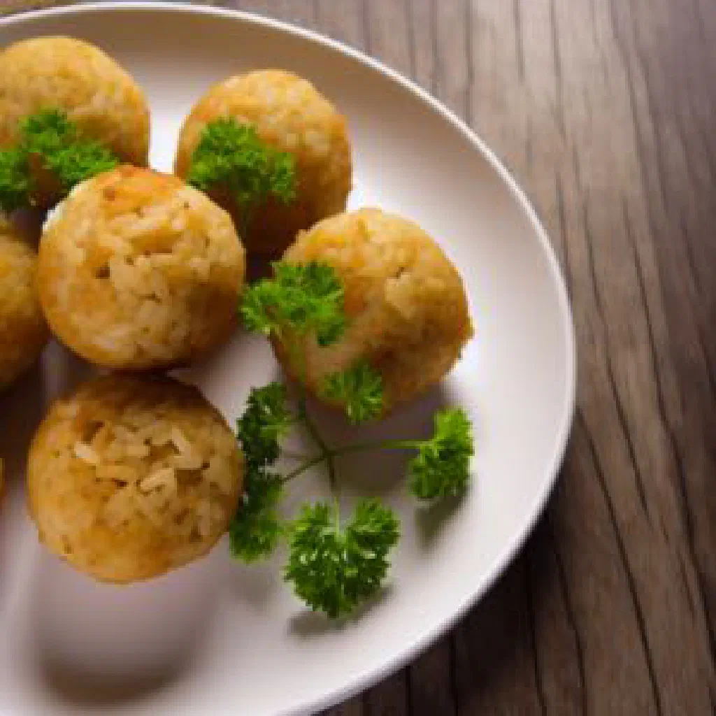 Golden fried Mofo Gasy rice balls dusted with sugar on a plate