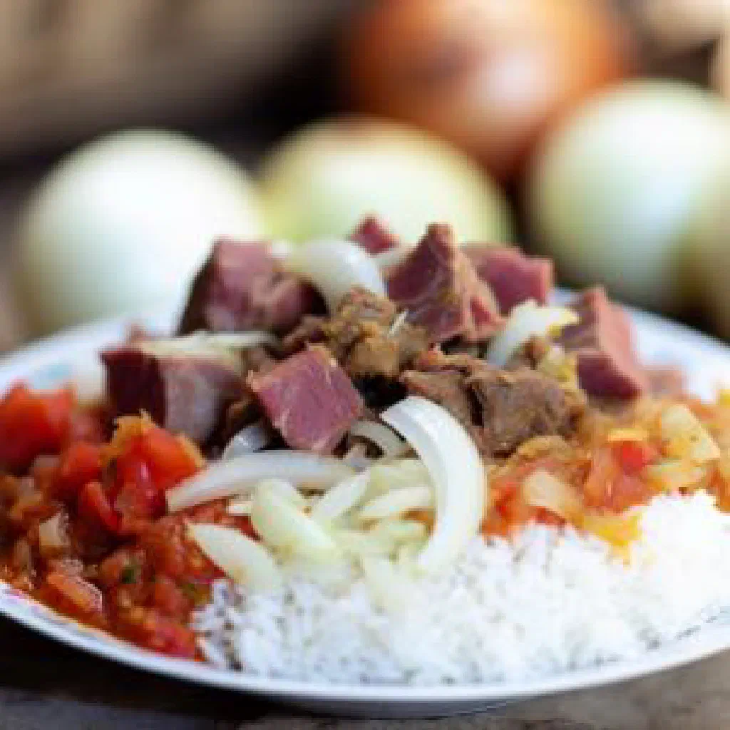 A bowl of Malagasy vary be menaka rice with vegetables and fresh herbs