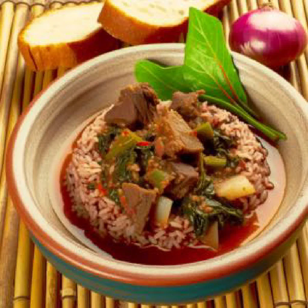 A bowl of Vary Ritra, spiced rice with meat and vegetables, garnished with fresh herbs