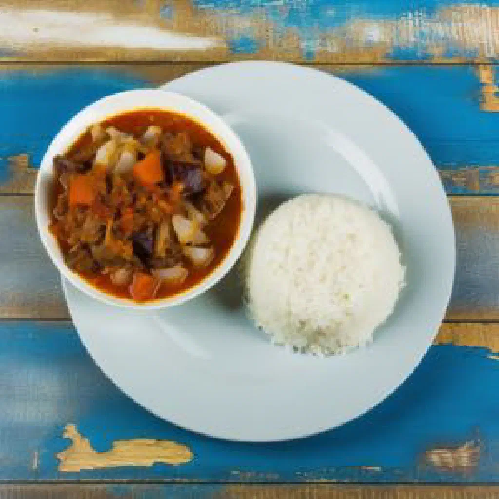 A bowl of Vary Sosoa rice with chicken, vegetables and fresh herbs