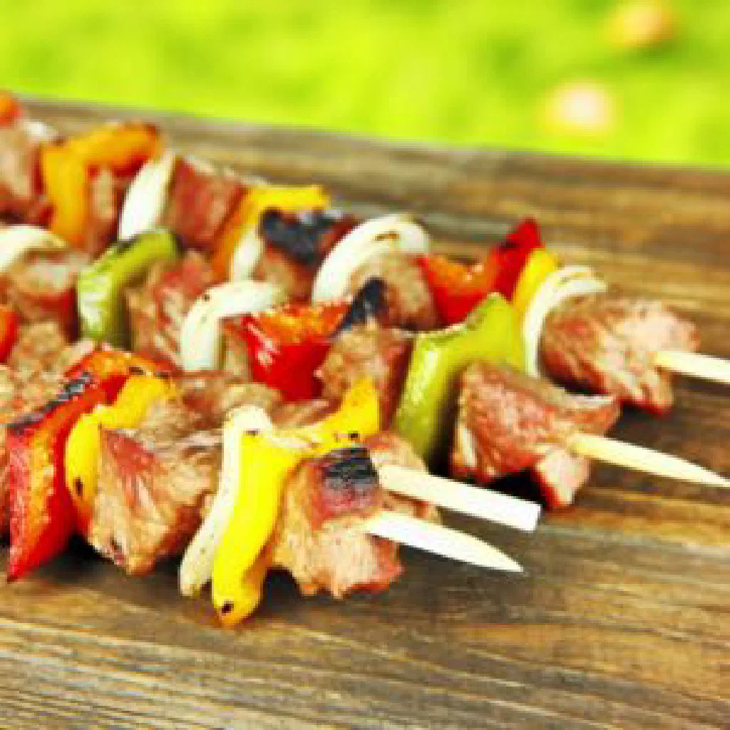 Marinated grilled Kachoma skewers served with charred vegetables